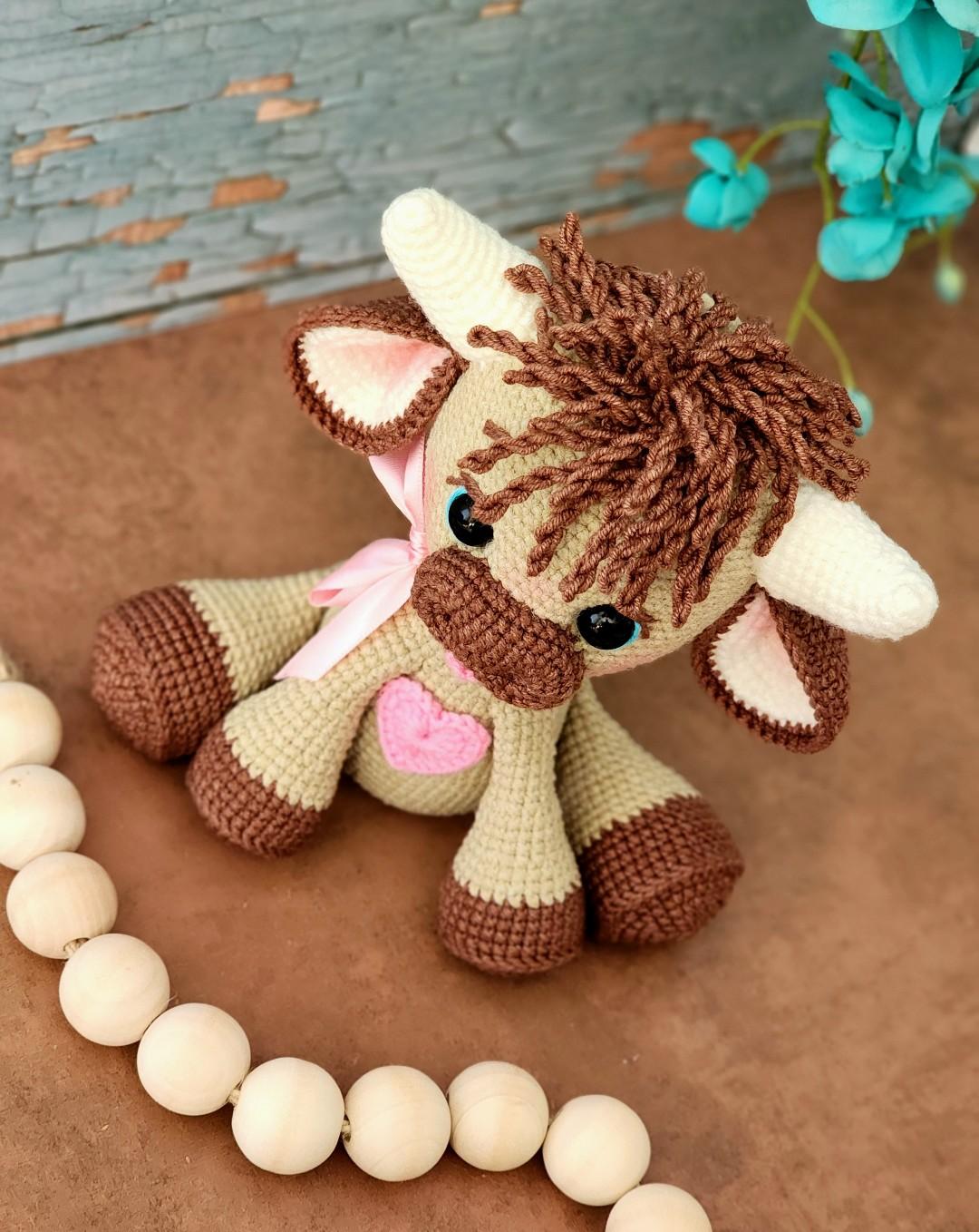 Tester-made Olly tilting his head beside a strand of wooden beads