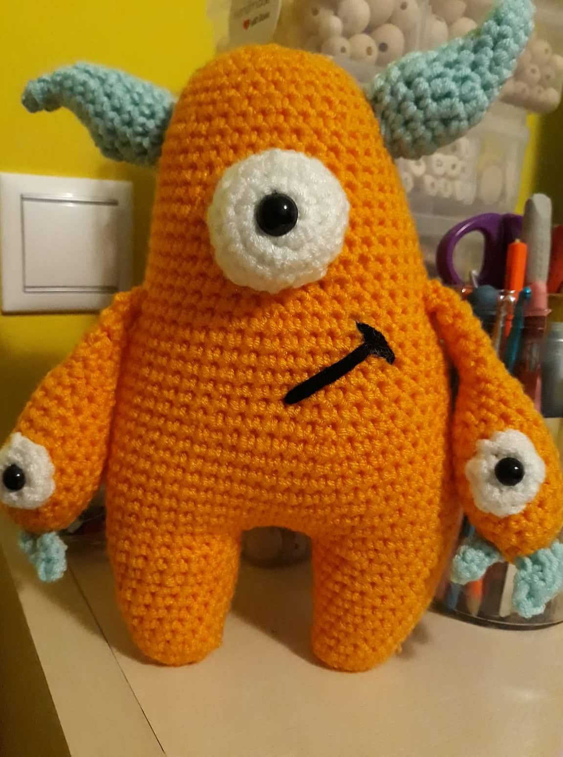 Orange crochet Quill with pale blue horns and hands