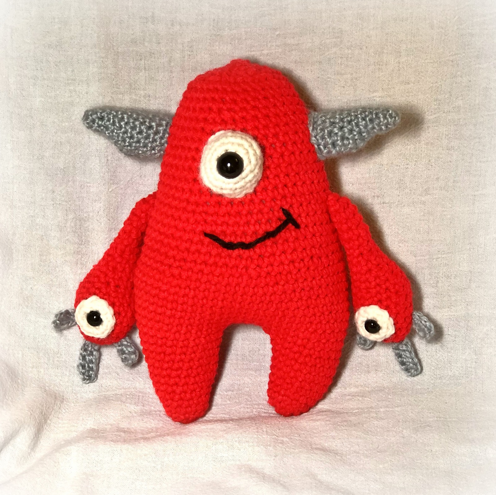 Bright red crochet Quill with silver grey horns and hands