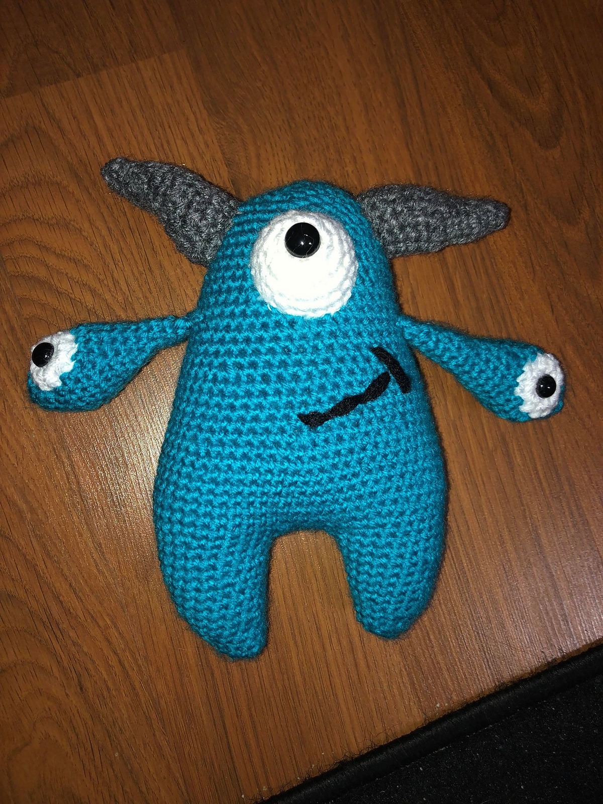 Teal crochet Quill with charcoal grey horns